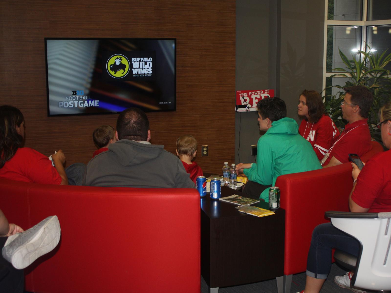 Families watch the Husker football game from the Nebraska Union.