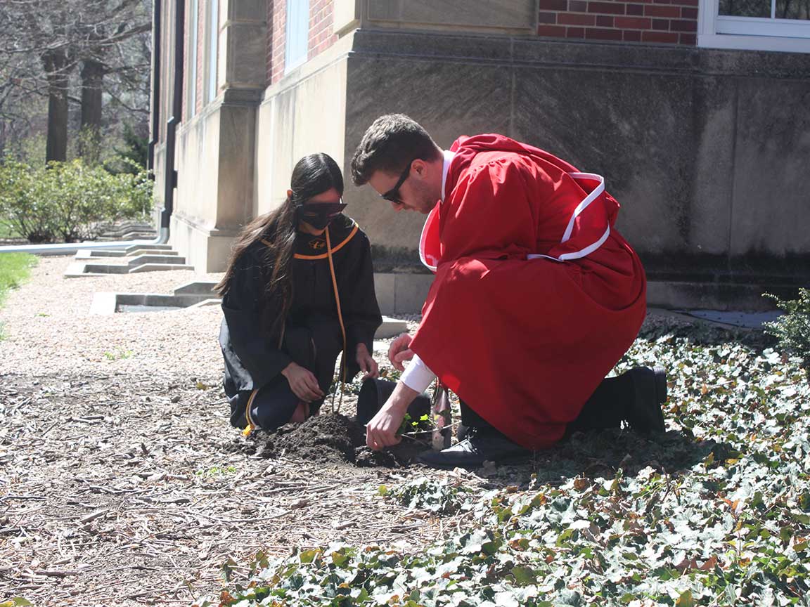 Innocents Society and Mortar Board presidents plant ivy at Ivy Day 2016. 