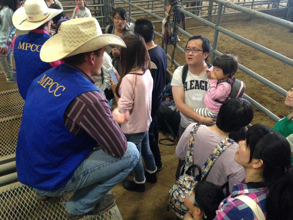 International students and family members get a behind the scenes tour of the rodeo.