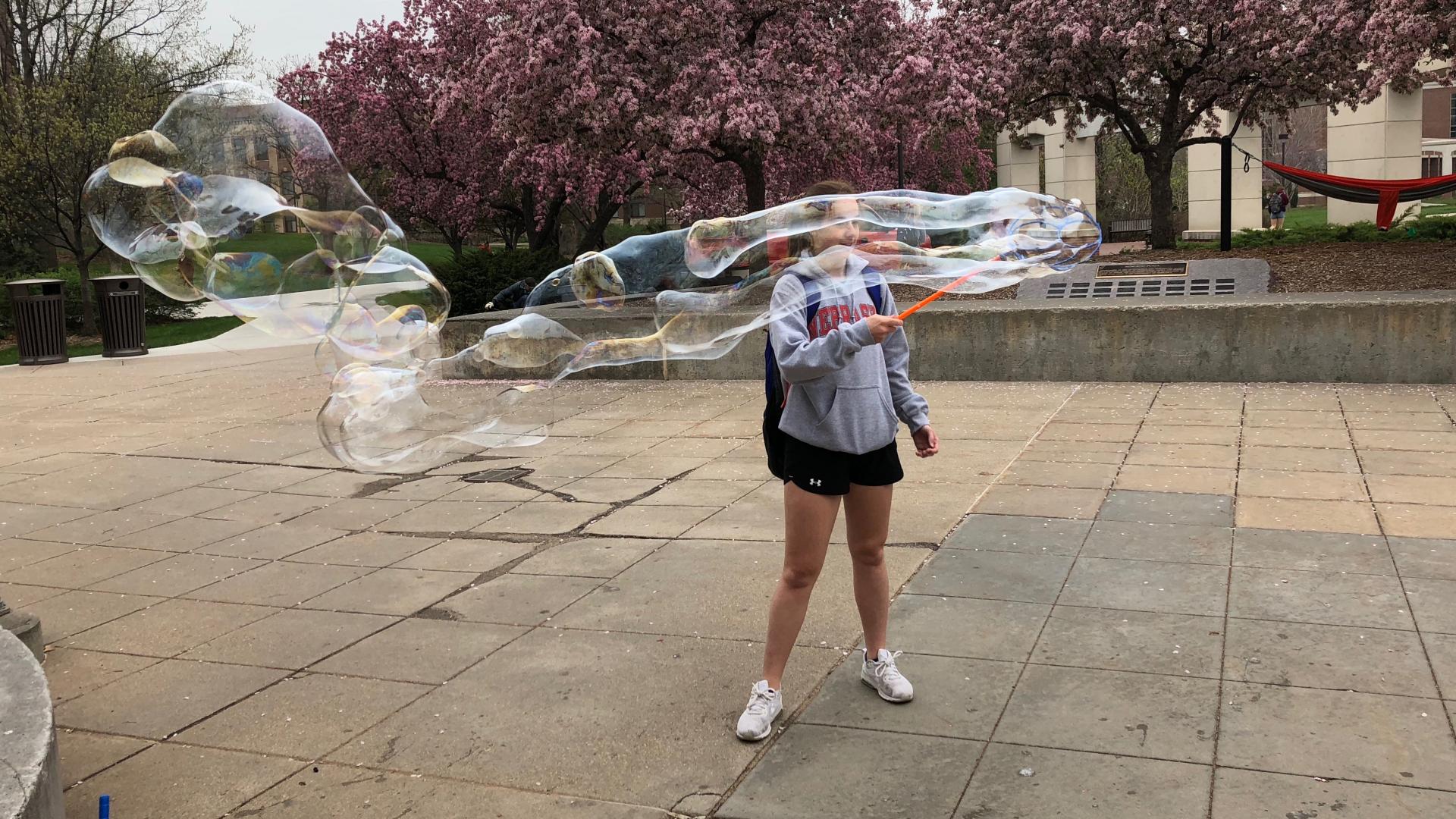 A student relaxes by blowing bubbles during finals week.
