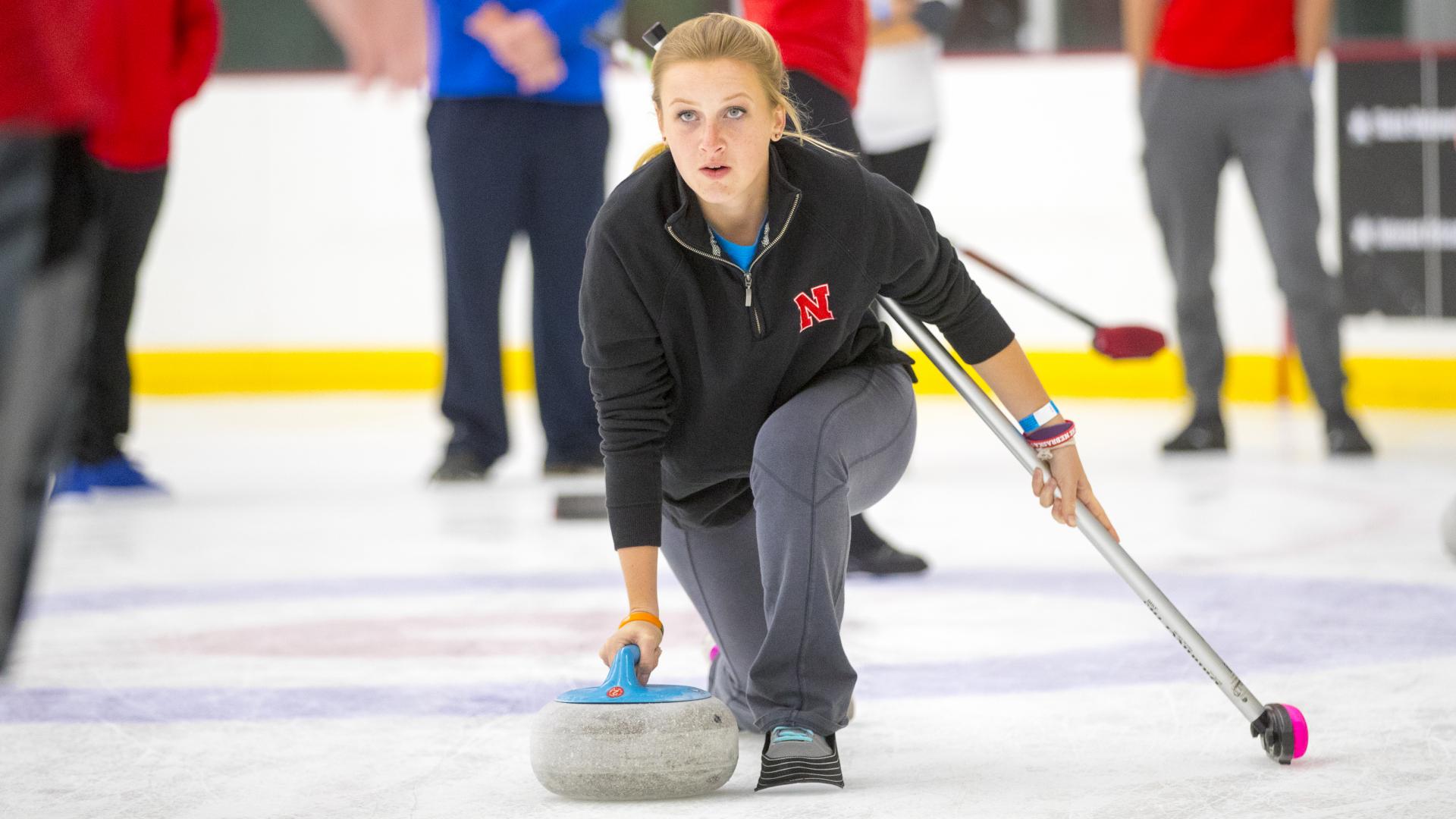 A member of the Nebraska Curling Club practices at the Breslow Ice Center.