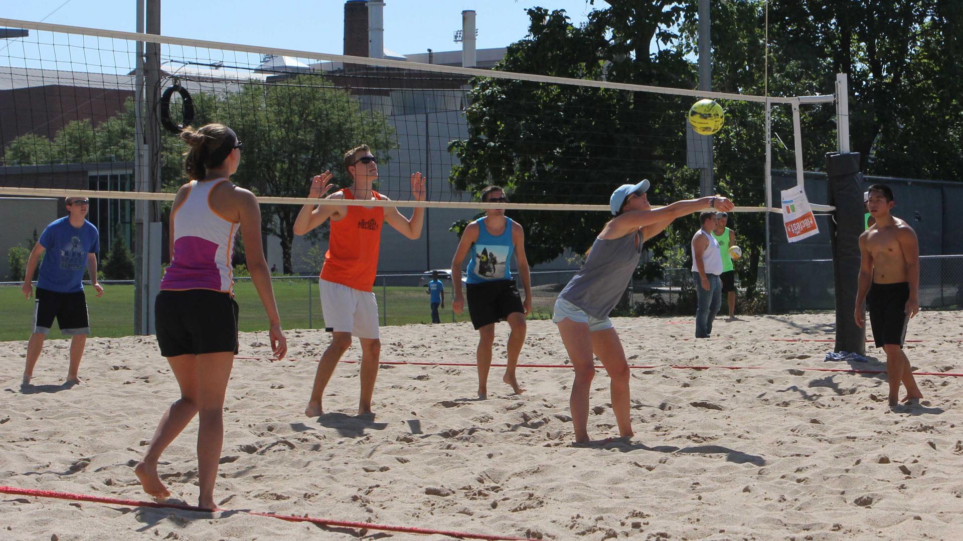 Students play intramural sand volleyball